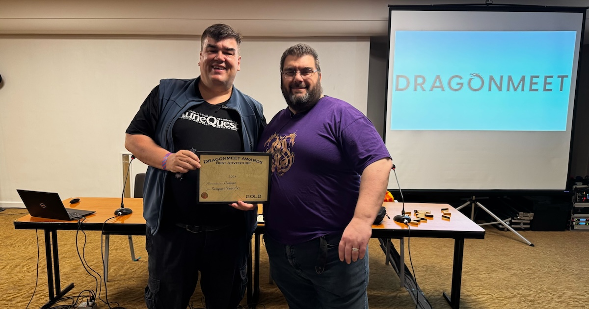 Chaosium's Michael O'Brien (MOB) receiving the award from Dragonmeet organiser John Dodd